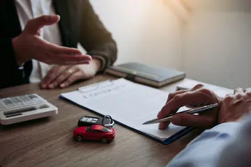 A consumer reviewing a vehicle service protection contract to verify coverage details and exclusion lists before purchasing.